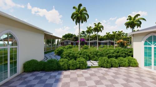 Vue extérieure d'un complexe hôtelier avec des arbres et des buissons dans l'établissement Trishvam Palolem Beach Resort, à Canacona