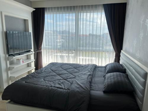 Ένα ή περισσότερα κρεβάτια σε δωμάτιο στο The patio บางแสน