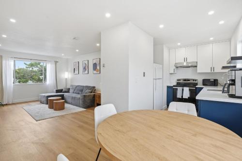 eine Küche und ein Wohnzimmer mit einem Holztisch im Zimmer in der Unterkunft Modern 2BR Unit with Covered Parking in Santa Clara apts in Santa Clara