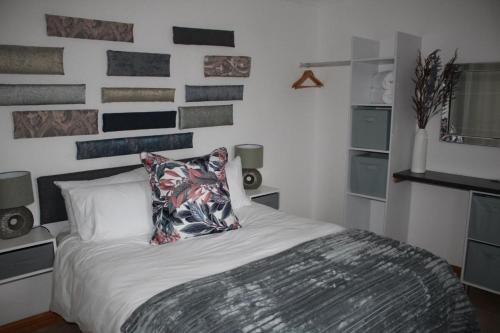 a bedroom with a bed with a pillow on it at Cottage of Grace in Benoni