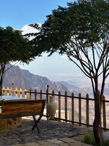 a bench on a patio with a view of the mountains at Dana luxury huts in Dana