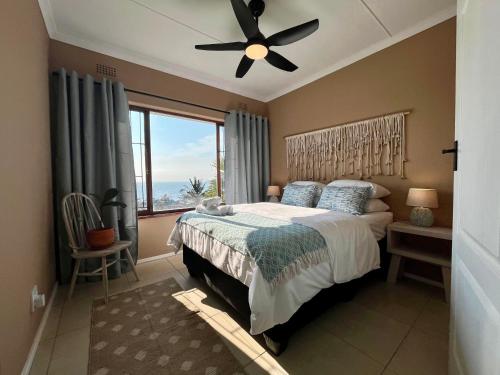 a bedroom with a bed and a ceiling fan at Casa Bellé Bluff in Durban