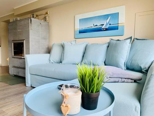 a living room with a couch and a table at Haus am See in Möhnesee