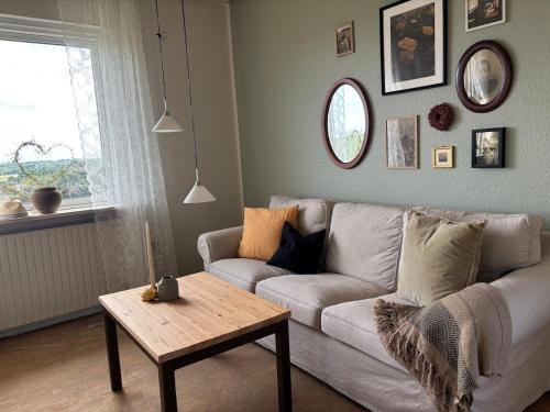 a living room with a couch and a table at Grandmothers home in Randers