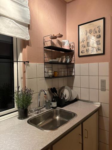 a kitchen with a sink and a counter top at Grandmothers home in Randers
