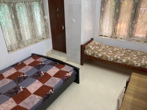 Ένα ή περισσότερα κρεβάτια σε δωμάτιο στο nandanam villlas