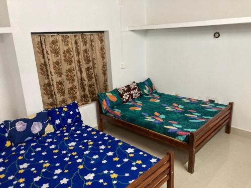 a living room with a bed and a couch at nandanam villlas in Guruvāyūr