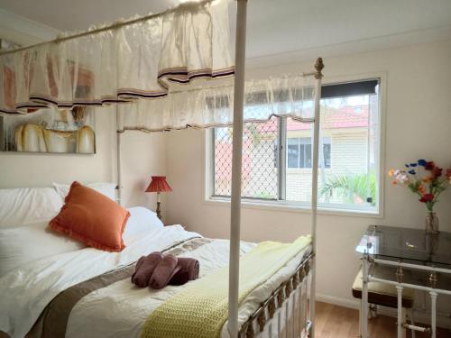 a bedroom with a canopy bed and a window at Youth Castle in Brisbane