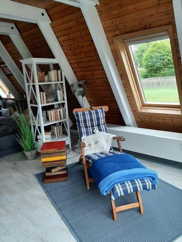 a chair sitting on a rug in a room with a window at Zum-Piraten in Damp