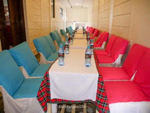 Una mesa larga con botellas de agua encima. en Silantoi hotel, en Gatunga