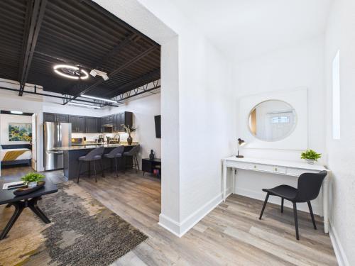 a kitchen and living room with a table and chairs at Loft Getaway Near Port & Beach -Unit 203 in Cape Canaveral