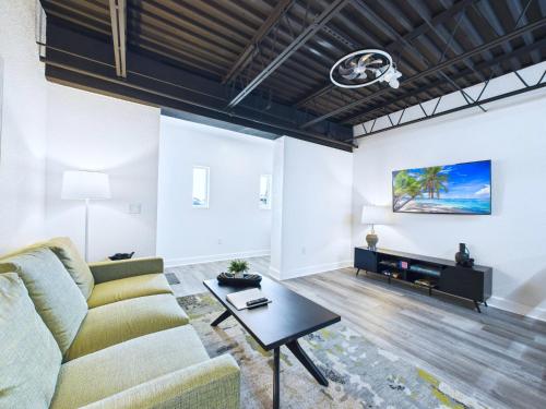 a living room with a couch and a table at Bright Modern Loft by Port & Beaches -Unit 206 in Cape Canaveral