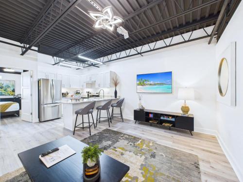 an open living room with a kitchen and dining area at Modern Loft near Port, Beach, & Dining -Unit 201 in Cape Canaveral