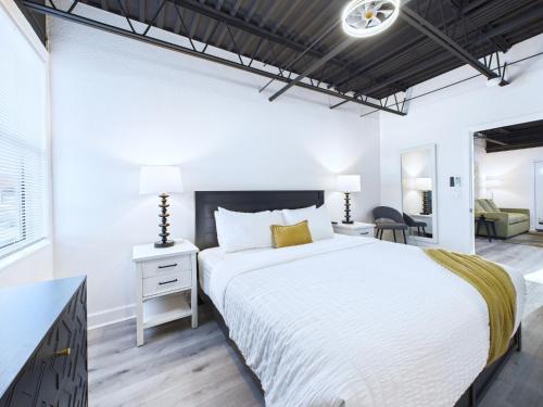 a bedroom with a large bed and a desk at Stylish Loft Minutes From Beach & Port - Unit 204 in Cape Canaveral