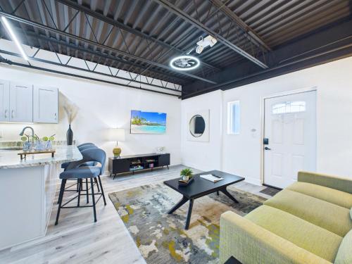 a living room with a couch and a table at Sleek Coastal Loft Close to Port & Beach -Unit 205 in Cape Canaveral