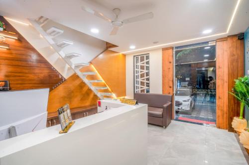a spiral staircase in a living room with a couch at Hotel Deol's Paradise in Indore