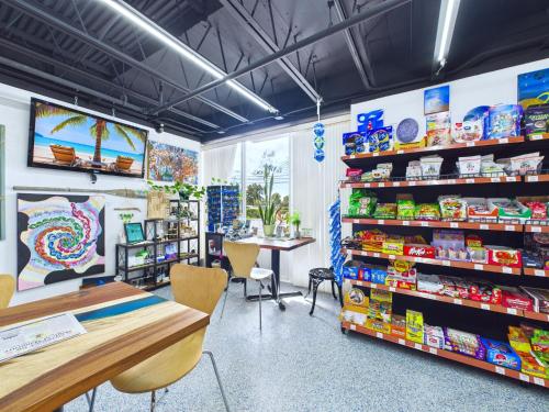 a store with a table and chairs in a room at Minutes to Port! Loft Near Dining & Fun -Unit 207 in Cape Canaveral
