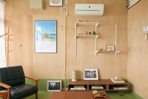 a living room with a chair and a table at A cozy home between Osaka and Kyoto -UNiCO- in Takatsuki