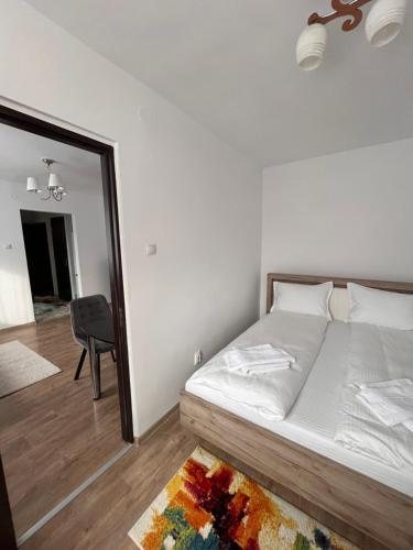 a bedroom with a large bed and a mirror at Focus Residence in Miercurea-Ciuc