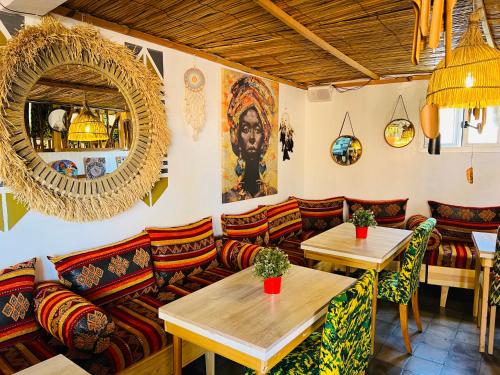 a restaurant with couches and tables in a room at Art riad mazighen in El Jadida