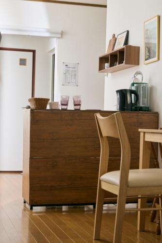 a kitchen with a wooden counter and a chair at A cozy home between Osaka and Kyoto -UNiCO- in Takatsuki