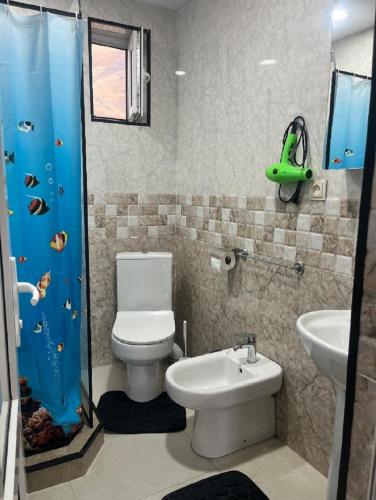 a bathroom with a toilet and a sink at Mountain flower cottage in Kazbegi