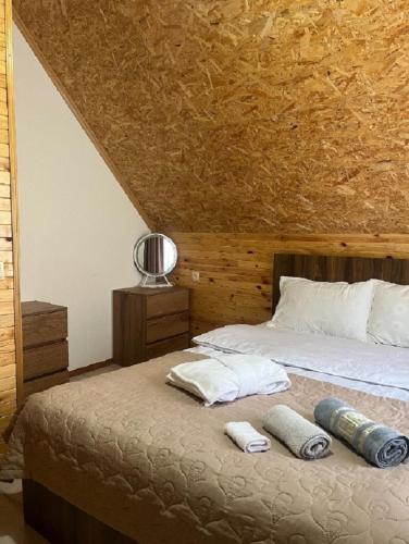 a bedroom with a bed with two pillows on it at Mountain flower cottage in Kazbegi
