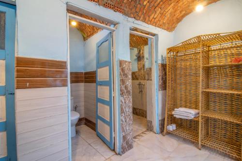 a bathroom with a walk in shower and a toilet at Pharaohs Rest Luxor in Luxor