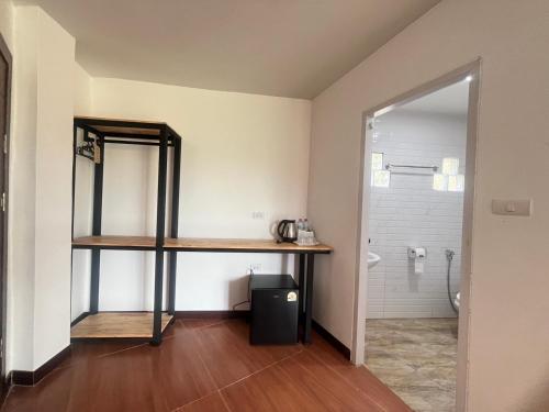 une salle de bain avec un lavabo, une étagère et un miroir dans l'établissement Lucky 9 Airport Hotel Phuket, à Nai Yang Beach