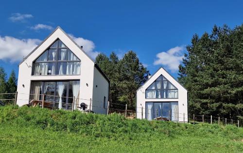 a white house on top of a hill at MotoChillout Bieszczady in Polańczyk