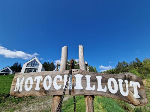 a wooden sign with the word not out at MotoChillout in Polańczyk