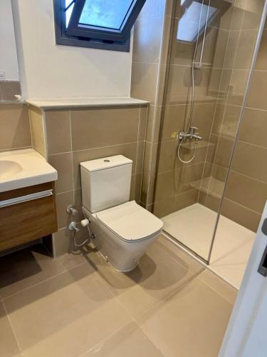 a bathroom with a toilet and a shower at 4 Bedrooms Penthouse Villa, Marassi in El Alamein