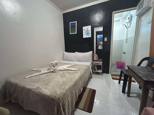 a bedroom with a bed with a ribbon on it at Dean's Homestay Siargao in General Luna