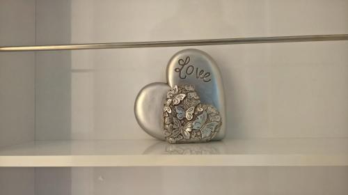 a shelf with a heart shaped object with the word love at amazing apartments - Annandale St near The Playhouse - Free Parking in Edinburgh