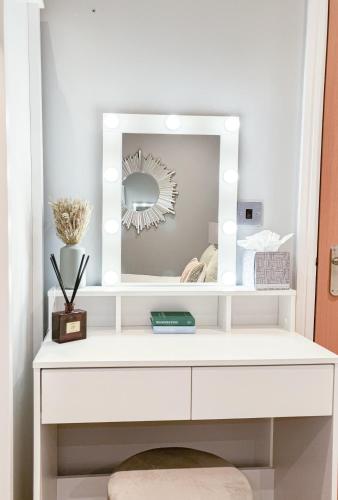 a white dressing table with a mirror on it at Lady Peckett's Yard in York
