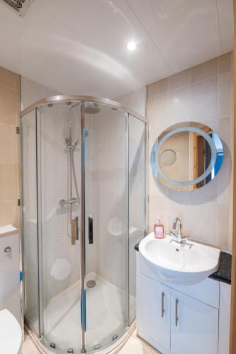 a bathroom with a shower and a sink at Blue Pool View in Portrush