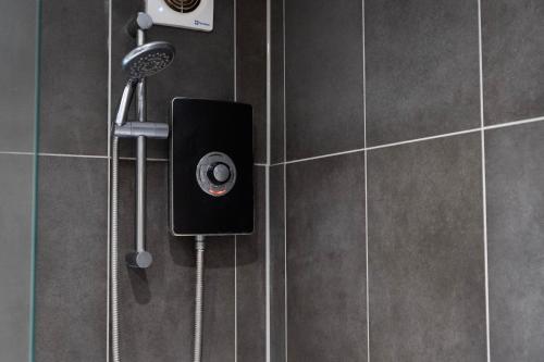 a shower with a shower head in a bathroom at Stylish 2BR Retreat - Sleeps 6 - Central Chatham in Chatham