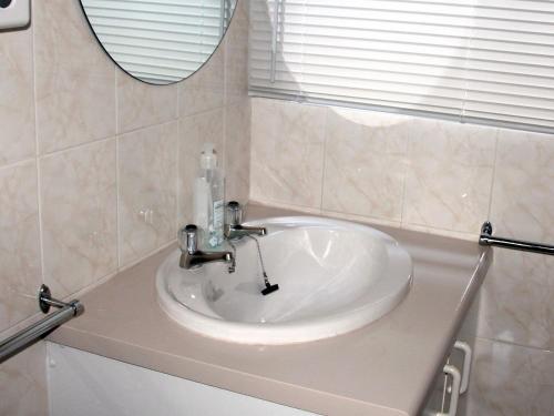 a white sink in a bathroom with a mirror at Sea Why in Natureʼs Valley