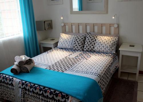 a bedroom with a bed with a teddy bear on it at Sea Why in Natureʼs Valley