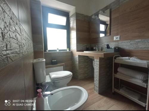 a bathroom with a toilet and a sink at Fontanarossa Airport Sleep and Travel 1 in CTA