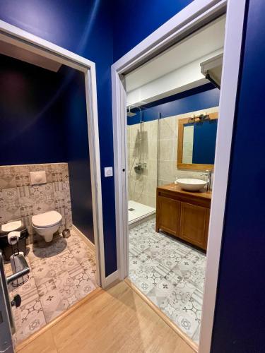 a bathroom with a toilet and a sink and a shower at Hotel LA PLACE in Saint-Amand-Montrond