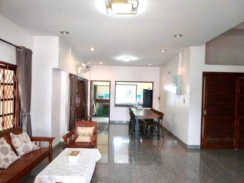 a living room with a couch and a table at Mata Villa Krabi Town in Krabi