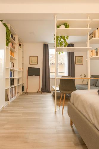 a bedroom with a bed and a desk and a bunk bed at CASA BIA in Bergamo