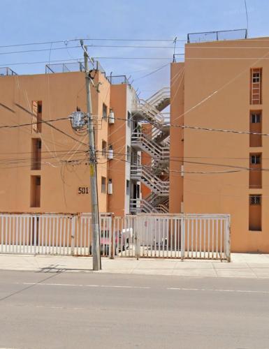 an empty street in front of a building at Departamento Completo en el Sur in León