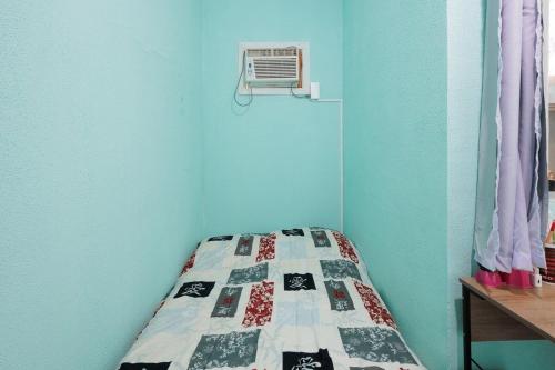 a bedroom with a bed with a quilt on it at Casa Branca 355 Familiar in Rio de Janeiro