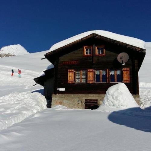 a log cabin with snow on top of it at Chalet Abendruh Belalp in Naters