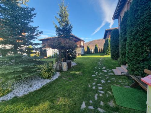 a garden with a stone path and a house at Villa Nikol Apartment #2 in Raduil