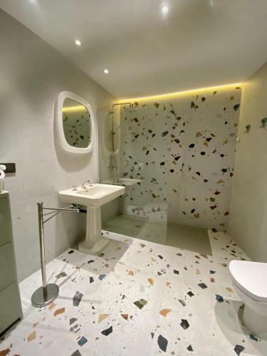 a bathroom with a toilet and a sink and a shower at Castro Romano VUT 7712 AS in Gijón