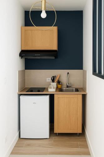 a kitchen with a sink and a counter top at Grand Studio entier proche de Tours in Esvres