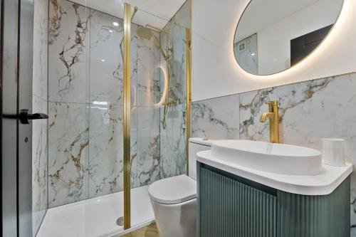 a bathroom with a sink and a mirror at Newly renovated Atherton home by Train station in Atherton